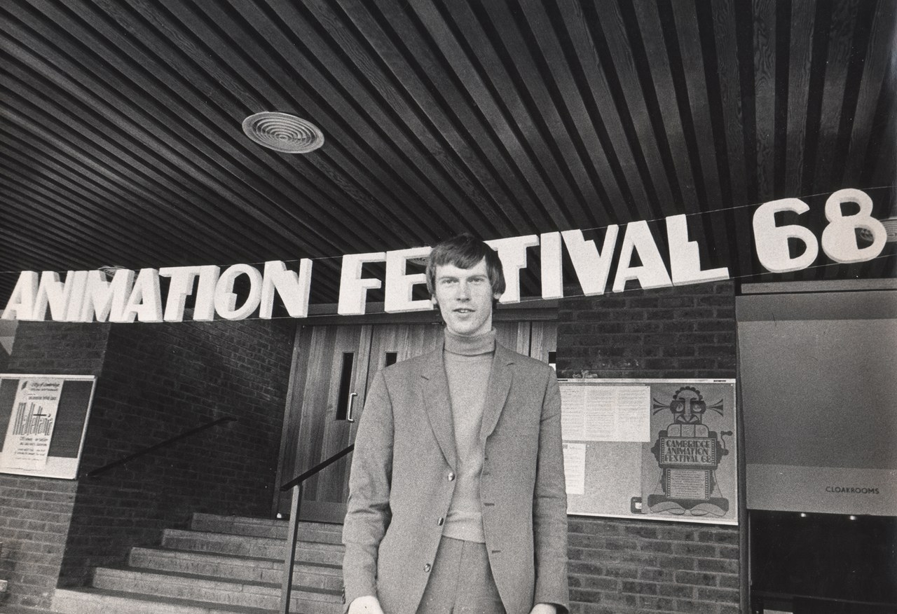 Dick Arnall standing beneath large lettering reading 'ANIMATION FESTIVAL 68' above the entrance steps