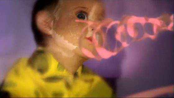 Still from Ray-Gun Fun by Simon Pummell: a child with a pink ray-gun trail across his face